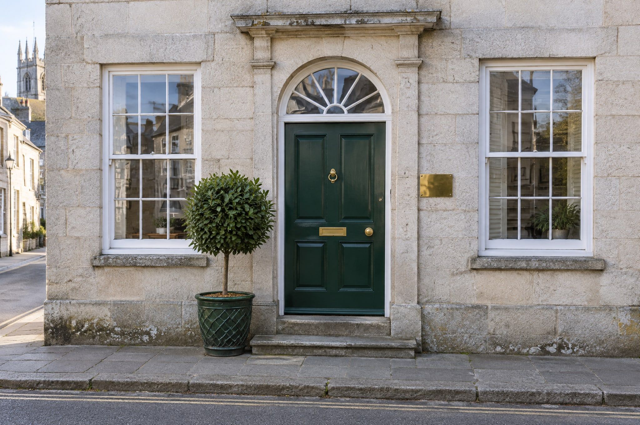 The Fearn Hollis office door on St John Street, Ashbourne: Georgian sash windows and a green front door
