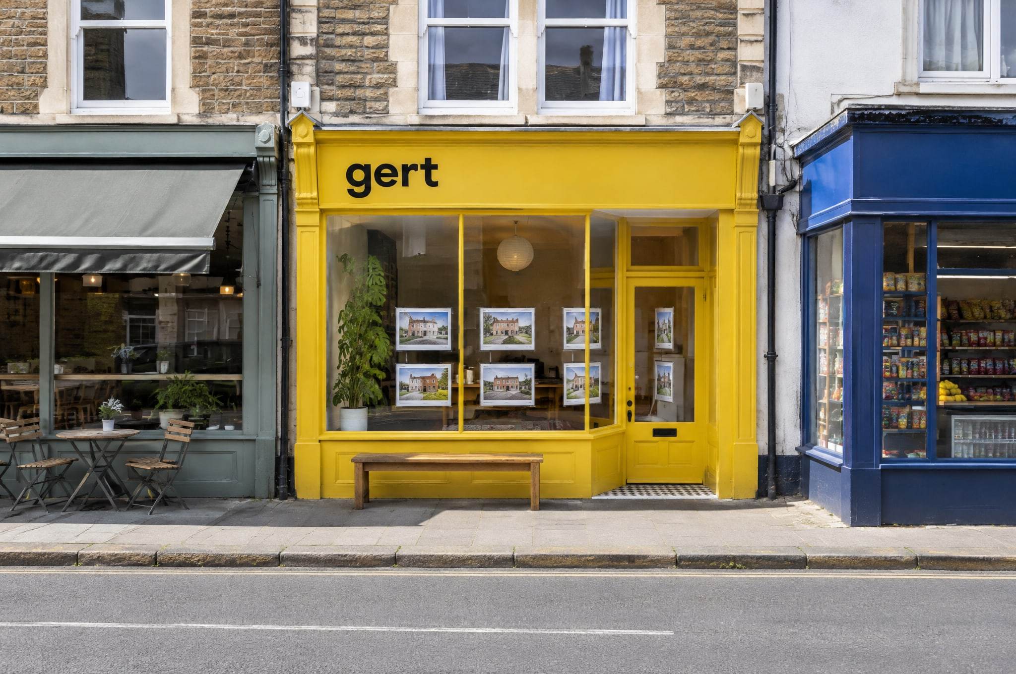 The Gert shop on Church Road: a yellow painted shopfront with the name in black letters, between a cafe and a corner shop