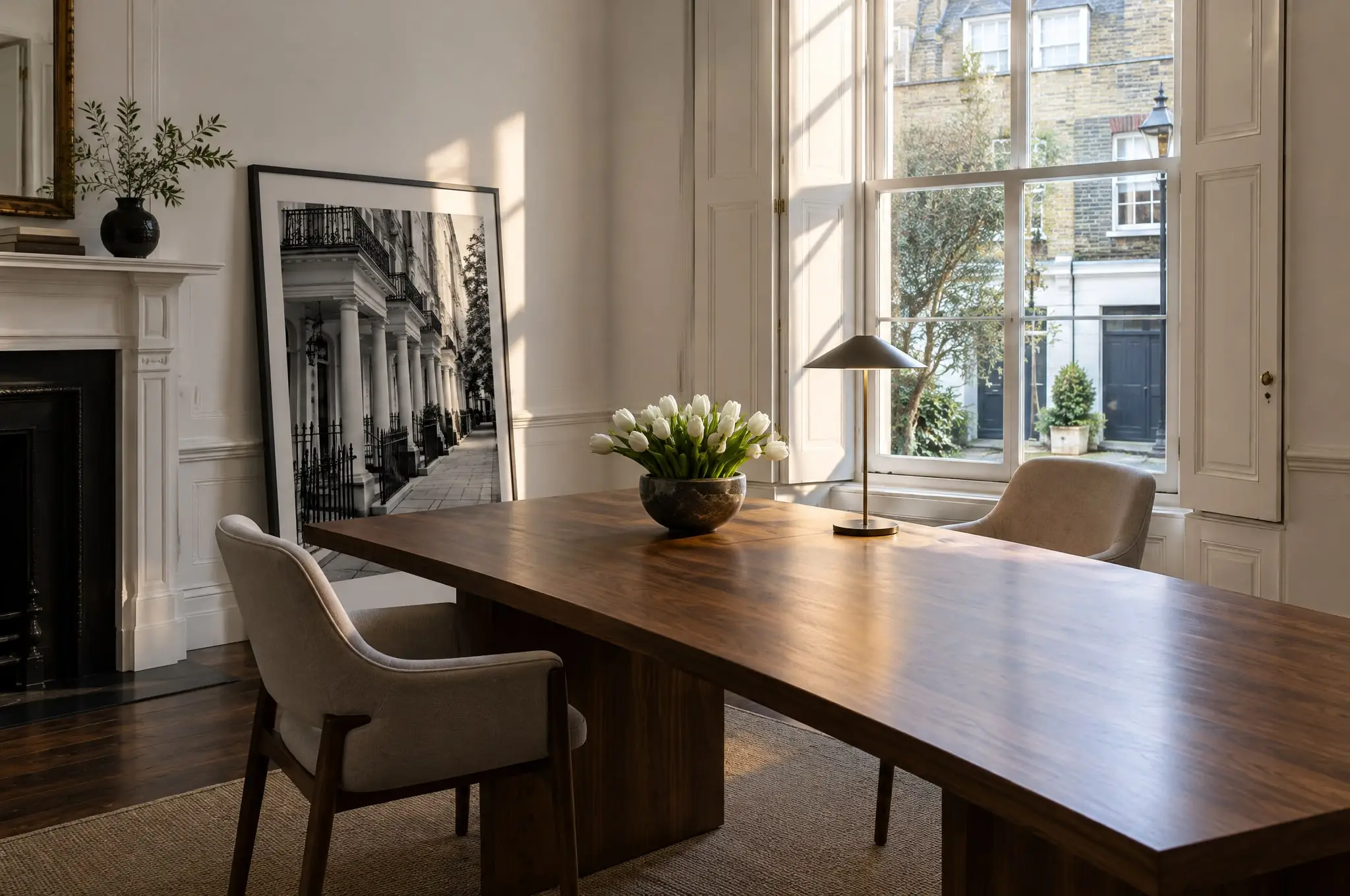 A first floor room with a long walnut table, two chairs and tall shuttered windows (a fictional office, made for this demonstration)